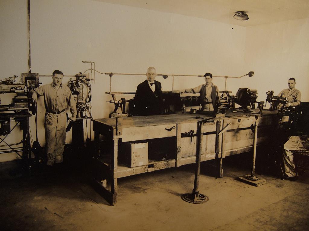 DSCF2510.JPG - Shoe Shop - note two stands in front of counter used to hold shoes while heels nailed on.  Grinder / buffer is behind the counter, stitching machine is in the back left (with two spools of thread on top)